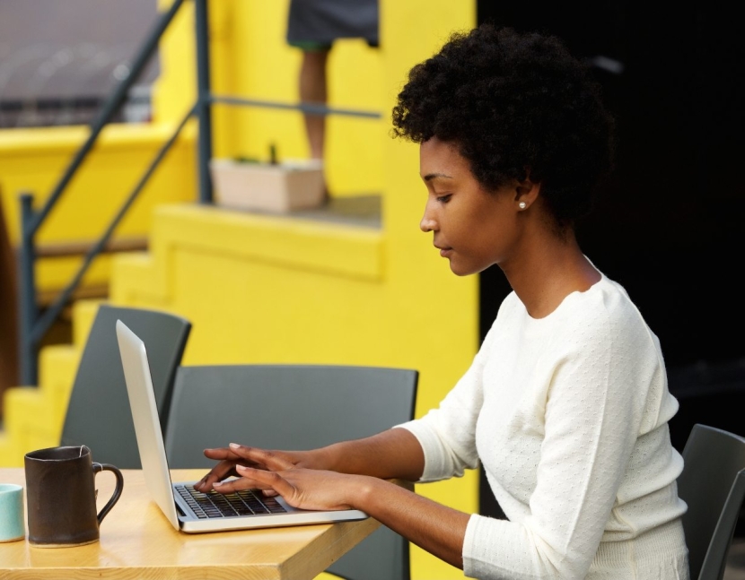 attractive-young-woman-using-laptop-outside-P9RLFGU@2x.jpg